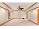 Large bedroom with a tray ceiling, ceiling fan, wood trim, carpeted floor, and two windows at 402 Clyde Ct, Mcdonough, GA 30252