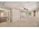 Cozy bedroom featuring soft carpeting, bright windows, and an open layout connecting to other living spaces at 402 Clyde Ct, Mcdonough, GA 30252