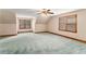 Bright bedroom featuring two windows, a ceiling fan, and neutral carpet flooring offering natural light at 402 Clyde Ct, Mcdonough, GA 30252