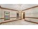 Bright dining room with carpet, large window, and stylish light fixture at 402 Clyde Ct, Mcdonough, GA 30252