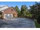 Large driveway with side-entry garage and brick exterior at 402 Clyde Ct, Mcdonough, GA 30252