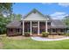 Stately brick home with grand white columns and a well-maintained front lawn at 402 Clyde Ct, Mcdonough, GA 30252