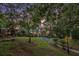 View of home from the wooded riverbank featuring landscape lighting at 402 Clyde Ct, Mcdonough, GA 30252