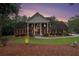 Brick home with manicured landscaping, decorative lighting, and a circular driveway at 402 Clyde Ct, Mcdonough, GA 30252