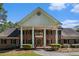 Traditional red brick home featuring white columns and neatly trimmed landscaping at 402 Clyde Ct, Mcdonough, GA 30252