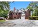 Rear view of a brick two-story home with an attached garage and private pool at 402 Clyde Ct, Mcdonough, GA 30252