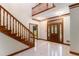 Elegant foyer featuring a staircase, tile flooring, and a decorative wooden front door at 402 Clyde Ct, Mcdonough, GA 30252