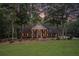 Two-story brick home with a columned porch and manicured front yard at 402 Clyde Ct, Mcdonough, GA 30252