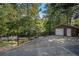 Detached brick garage with large driveway and ample parking at 402 Clyde Ct, Mcdonough, GA 30252