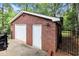 Detached two-car brick garage with two bays and side door, offering ample parking and storage at 402 Clyde Ct, Mcdonough, GA 30252