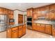 Kitchen featuring stainless steel appliances, wood cabinets, hardwood flooring, and kitchen island at 402 Clyde Ct, Mcdonough, GA 30252