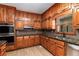 Kitchen featuring wood cabinets, stainless steel appliances, and tile backsplash at 402 Clyde Ct, Mcdonough, GA 30252