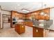Well-equipped kitchen featuring hardwood floors, kitchen island, tile backsplash, and wood cabinets at 402 Clyde Ct, Mcdonough, GA 30252