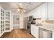 Efficient kitchen with stainless steel appliances, white cabinetry, and wood-look flooring at 402 Clyde Ct, Mcdonough, GA 30252