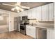 Compact kitchen equipped with stainless steel appliances, white cabinets, and practical countertops, offering efficient cooking space at 402 Clyde Ct, Mcdonough, GA 30252
