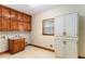 Functional laundry room with wood cabinets, sink, and large storage space offering practicality and convenience at 402 Clyde Ct, Mcdonough, GA 30252
