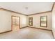 Spacious living room featuring neutral carpet, wood trim, and natural light at 402 Clyde Ct, Mcdonough, GA 30252