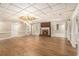 Open living room boasting hardwood floors, a classic brick fireplace, and abundant natural light, perfect for entertaining at 402 Clyde Ct, Mcdonough, GA 30252