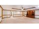 Large living room with carpet flooring, ceiling fan, and wood trim at 402 Clyde Ct, Mcdonough, GA 30252