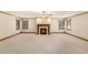 Large living room with a fireplace as a focal point and natural light from windows at 402 Clyde Ct, Mcdonough, GA 30252