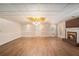 Large living room with a brick fireplace, hardwood floors, and ample space for entertaining and relaxation at 402 Clyde Ct, Mcdonough, GA 30252