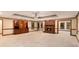 Open living room featuring a brick fireplace, wood trim, and plush carpeting at 402 Clyde Ct, Mcdonough, GA 30252