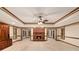 Open living room featuring a brick fireplace, wood trim, and plush carpeting at 402 Clyde Ct, Mcdonough, GA 30252