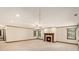 A living room has a fireplace, windows, baseboard trim, and carpet at 402 Clyde Ct, Mcdonough, GA 30252