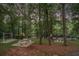 Multiple picnic tables and a swing on the banks of a river create a cozy outdoor dining area at 402 Clyde Ct, Mcdonough, GA 30252