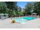 Inviting pool area featuring a waterfall feature, a poolside gazebo, and lush landscaping at 402 Clyde Ct, Mcdonough, GA 30252