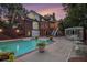 Outdoor pool and deck area featuring the house and surrounding foliage in a beautiful backyard setting at 402 Clyde Ct, Mcdonough, GA 30252
