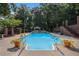 Private backyard pool with waterfall feature and brick accents at 402 Clyde Ct, Mcdonough, GA 30252