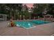 Inviting backyard pool featuring well-maintained landscaping, a charming gazebo, and soothing waterfall feature at 402 Clyde Ct, Mcdonough, GA 30252