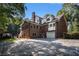 Rear view of a brick home with a fenced yard and an attached garage at 402 Clyde Ct, Mcdonough, GA 30252