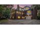 Evening view of a brick home with an attached garage and a fenced yard at 402 Clyde Ct, Mcdonough, GA 30252