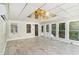 Bright sunroom with tile floors, walls of windows, and a unique gold ceiling at 402 Clyde Ct, Mcdonough, GA 30252