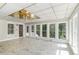 Inviting sunroom with tile floors, plenty of natural light, and a unique ceiling at 402 Clyde Ct, Mcdonough, GA 30252