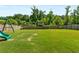 The spacious backyard features a playground and is surrounded by a privacy fence and mature trees at 5240 Bristlecone Pine Way, Cumming, GA 30040
