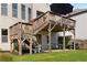 A charming backyard deck with stairs leading to a cozy patio, ideal for outdoor dining and relaxation at 5240 Bristlecone Pine Way, Cumming, GA 30040
