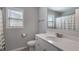 Bright bathroom features white fixtures, a single sink vanity, and a shower-tub combination with a window at 5240 Bristlecone Pine Way, Cumming, GA 30040