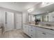 Bathroom featuring a double vanity with granite counters and a shower with a glass door at 5240 Bristlecone Pine Way, Cumming, GA 30040
