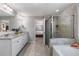 This bathroom has double vanities with granite countertops, a glass enclosed shower and a separate tub at 5240 Bristlecone Pine Way, Cumming, GA 30040
