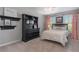 Charming bedroom with a black dresser, shelves and trim, complemented by pink curtains and a ceiling fan at 5240 Bristlecone Pine Way, Cumming, GA 30040
