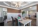 Elegant dining room with coffered ceiling, wainscoting, and a seamless transition to other living spaces at 5240 Bristlecone Pine Way, Cumming, GA 30040
