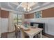 Elegant dining room with coffered ceiling, wainscoting, and a large window for natural light at 5240 Bristlecone Pine Way, Cumming, GA 30040