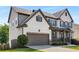 Charming two-story home featuring a brick and siding exterior, well-manicured lawn and a two-car garage at 5240 Bristlecone Pine Way, Cumming, GA 30040