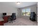 Functional office space with a desk, comfortable chair, and a large window offering natural light at 5240 Bristlecone Pine Way, Cumming, GA 30040