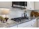 Close-up of a modern kitchen featuring stainless steel appliances and granite countertops at 5240 Bristlecone Pine Way, Cumming, GA 30040