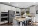 Spacious kitchen featuring stainless steel appliances, granite countertops, and a center island with barstool seating at 5240 Bristlecone Pine Way, Cumming, GA 30040