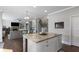 A kitchen island with granite countertop and white cabinetry complements the open-concept living space at 5240 Bristlecone Pine Way, Cumming, GA 30040